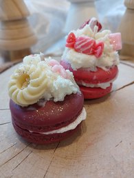  A white, ceramic Santa Claus candle with a jolly, round shape and a long, white beard. The candle is surrounded by small, decorative Christmas trees, creating a festive holiday scene.