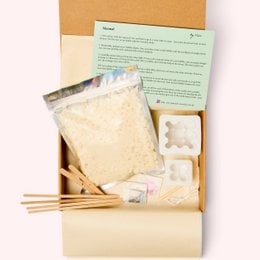 DIY box bubble candle kit containing wax, wick, and tools for creating a handmade candle. Includes instructions for a fun crafting project.