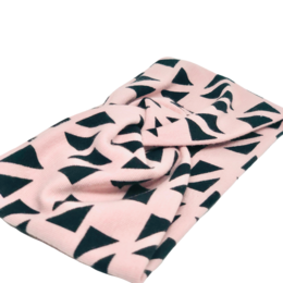 Twist the Leopard headband in a pink and black geometric pattern. Made of soft, stretchy material for a comfortable fit. Available in sizes S and L.