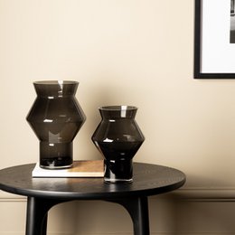 Dark grey, high-quality glass vase with a jagged, angular cylindrical shape.