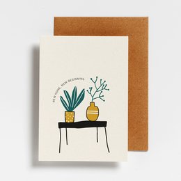 Postcard with illustration of potted plants on a table, text reads "New Home, New Beginning".