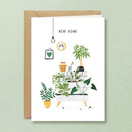 "Greeting Card | Moved | Repot" - A congratulations card featuring a cozy indoor scene with potted plants, a watering can, and other home decor items. The card is available in both English ("New home") and Dutch ("Verhuisd") versions.