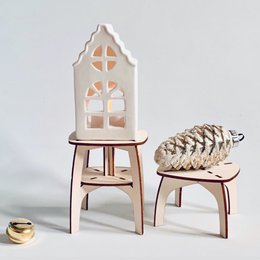Two small, decorative wooden tables for the windowsill, featuring a unique architectural design with cutout patterns. The tables are made of light-colored wood and have a simple, minimalist style.
