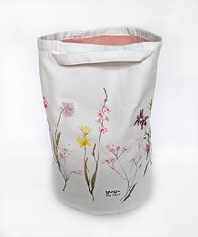 Floral patterned fabric storage basket with star-shaped cutouts, suitable for storing toys or other items in a child's room.