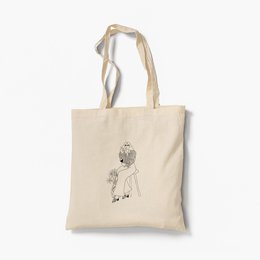 Organic tote bag with a simple sketch design of a person. The bag is made of natural cotton material and has a shoulder strap for easy carrying.
