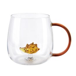  A clear glass mug with a wooden handle, featuring a whimsical hedgehog design inside the cup.