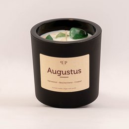 A round, tall black candle with a label that says "Augustus". The candle contains gemstone-like decorations.