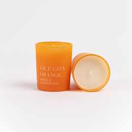 "Tall, round orange scented candle with amber and cedarwood fragrance."
