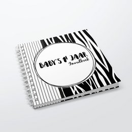 A black and white hardcover wire-o book titled "Baby's 1st year" with a zebra-patterned cover design.