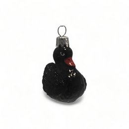 Black and white swan-shaped ornament with a red beak.