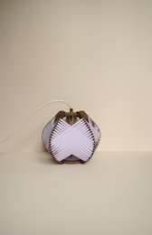 Lilac-colored table lamp with pleated fabric shade and brass hardware.