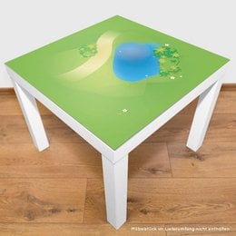 A green play mat with a grass landscape, a pond, and various toy animals and vehicles. The play mat is designed for children's imaginative play.