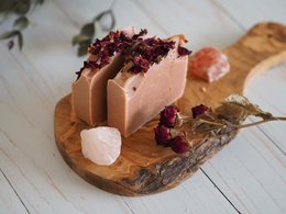 Handcrafted rose-scented soap bar with dried rose petals, a natural and soothing skincare product.