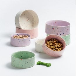 Two round, lilac-colored pet bowls with speckled patterns. Suitable for pet food or water.