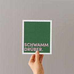  Green kitchen sponge with text "Schwamm druber" (German for "wipe it over") and "Natur Schwamm Tuber" (Natural sponge tube).
