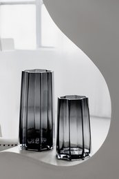 Tall, modern gray vase with stylish design and floral arrangement. Made of high-quality materials for a luxurious look.