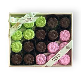 Mixed chocolate pralines box, green pink brown flavors, flower-shaped decorative packaging, assorted truffles