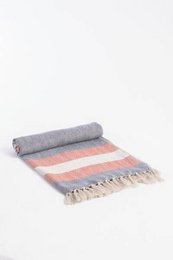 Linen herringbone throw in gray and pink tones with fringe details, suitable for use as a couch or bed cover.