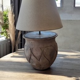  Rustic ceramic table lamp with a textured, patterned design in an earthy brown color.