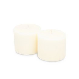 Two round, cream-colored candle refills with a 25-hour burn time. The candles are made from sustainable materials and come in Treasure and Tranquility scents.
