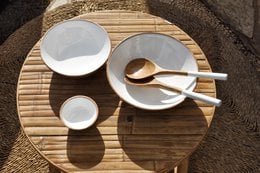 A set of medium-sized enamel mango wood bowls in an Ibiza style, featuring a round, shallow design with a natural wood grain texture.