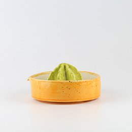 Bright orange lemon squeezer with a green juicing cone. Made of durable plastic material, suitable for kitchen use.