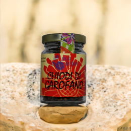 Whole organic cloves in a glass jar with a vibrant, colorful label featuring a floral design.