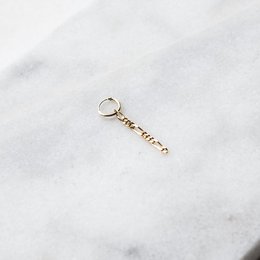 Long, thin hoop earrings made of sterling silver or 24k gold plated metal with a delicate, minimalist design.