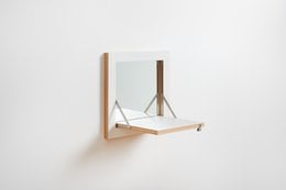 A rectangular wall-mounted vanity mirror with a black frame and wooden accents. The mirror has a simple, minimalist design and is suitable for use in a bathroom or bedroom.