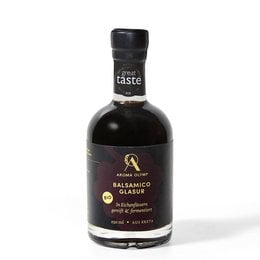 Organic balsamic glaze in a glass bottle. The product is a dark, thick balsamic vinegar glaze made from high-quality ingredients.