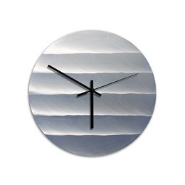 Polished aluminum wall clock with a modern, minimalist design featuring a gradient pattern in shades of gray. The clock has a round shape and a simple, clean aesthetic that would complement a variety of decor styles.