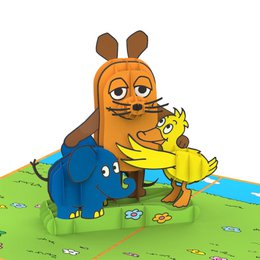 Colorful pop-up birthday card featuring a rabbit character hugging a yellow chick on a grassy field.