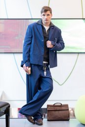  "Unstructured wool blazer in a classic navy blue color, made in Italy. Features a tailored fit and lapel collar."