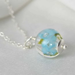 Delicate necklace with dark sky blue glass flowers pendant. Charms category.