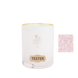 A tall, round white candle with a pink base and a gold-colored lid. The candle has the word "Lollia" printed on it in a cursive font.