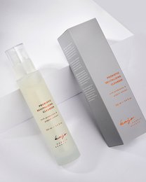Probiotic revitalizing cleanser in a clear bottle with a gray box. The bottle has a white label with orange text. The box has a white label with gray text.