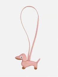 Cute dachshund-shaped bag charm in pink or black colors, made of durable materials, perfect as a keychain or accessory.