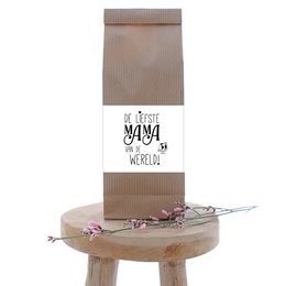 A ceramic mug with the text "The sweetest mama in the world!" printed on it. The mug has a simple, minimalist design with a light brown color and a wooden handle.