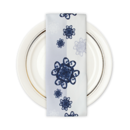 Two white napkins with a repeating pattern of navy blue floral designs.