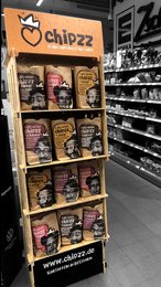 Freestanding display unit for Chipzz brand snacks, featuring various flavors and packaging designs.