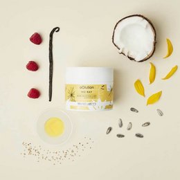 A cream-colored product with natural ingredients including coconut, raspberries, and turmeric. The product is described as 100% plant-based and non-toxic for the skin and the planet.