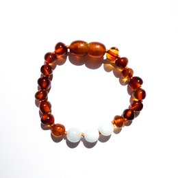 Baltic natural amber baby bracelet/anklet in a balance design, featuring amber beads in warm orange and yellow tones.