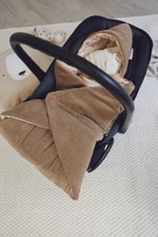  Soft, cozy corduroy swaddling blanket in neutral taupe and safari beige colors, perfect for wrapping up newborns and infants.