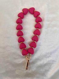  A heart-shaped phone cord in various pastel colors including fuchsia, light pink, light blue, lilac, orange, yellow, and light green.