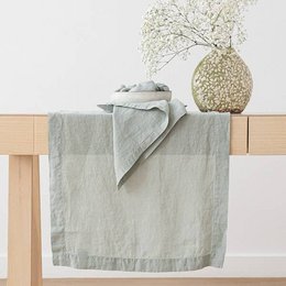 Linen runner in sea foam stone washed color, available in various sizes, suitable for table decor.