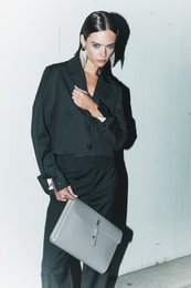  A grey pinstripe wool blazer with a cropped, unstructured design, suitable for women's formal wear.