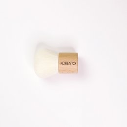 Soft, fluffy kabuki makeup brush with a wooden handle.