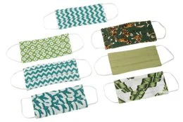 Reusable cotton face masks in various green and teal patterns, including polka dots, chevrons, and leaf designs.