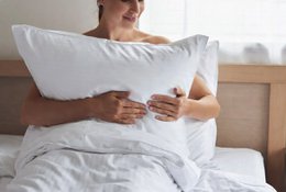  White polyester-cotton cushion cover, soft rectangular pillow case, bedroom bedding textile accessory.