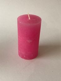 A cylindrical pink wax candle with a rough, rustic texture. The candle measures 70 x 130 mm and has a pink color.